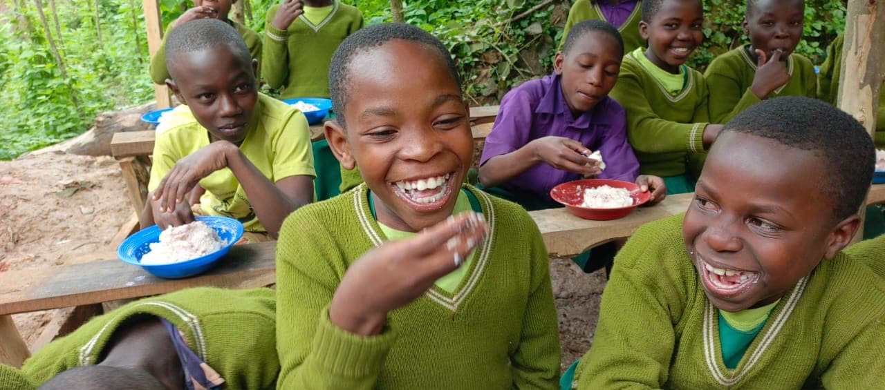 Community members and children benefiting from Rushaga Foundation programs in Bwindi region